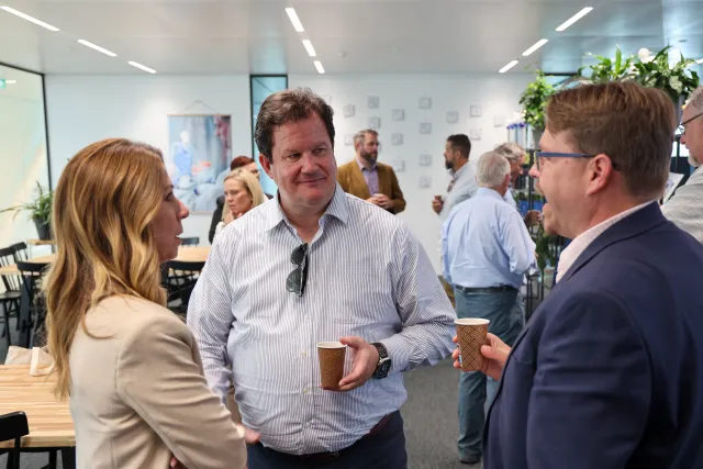 From left, a blonde woman, Gabe and Lucas stand speaking