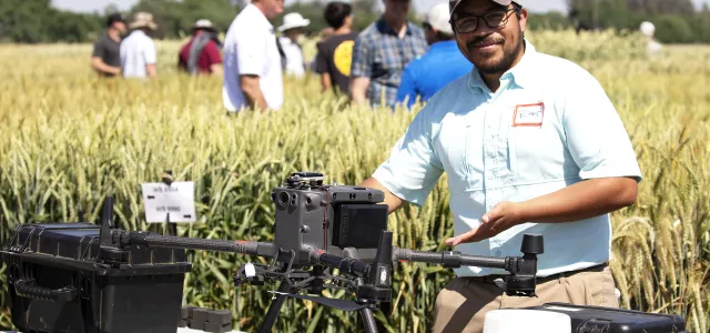 Person demonstrating drone at field crop day