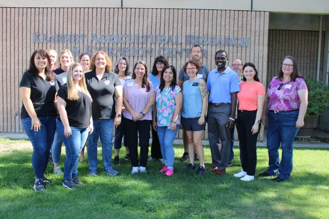 Group of people standing in front of a building.