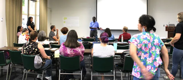 A person talking to a group of people.