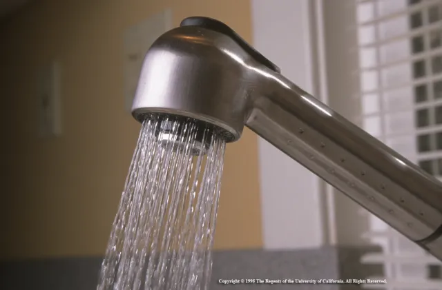 Water sprays from a kitchen faucet