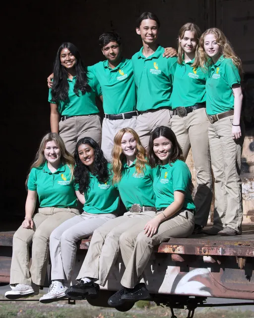 Young people in green 4-H shirts pose for a photo