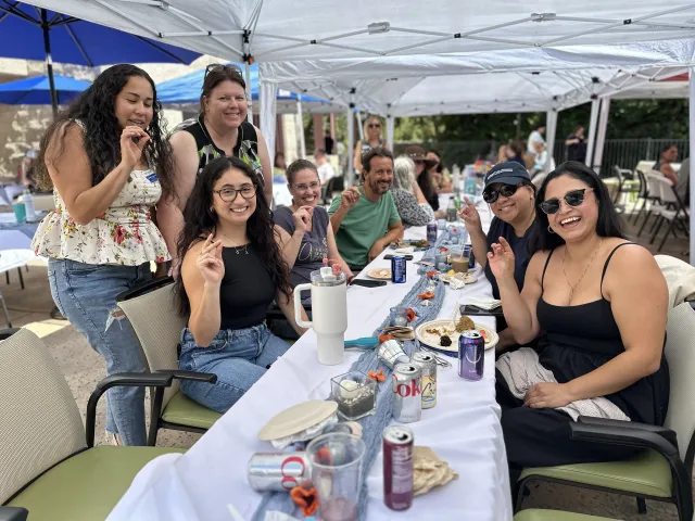 Group poses at a long table