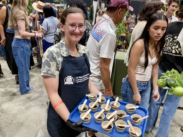 Carly holds a tray of jam samples