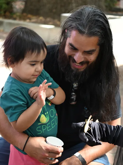 Freay Fien, 2, of Vacaville gets acquainted with Betty White while her father, Michael Fien watches. (Photo by Kathy Keatley Garvey)
