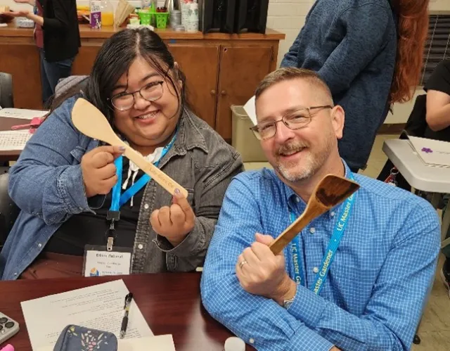 Program Coordinators, Randy Musser (Right, Orange County), and Erinne Rabanal (Left, Imperial County), show off their matching personal items during the Artifacts of Us ice-breaker activity. 