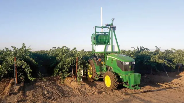Retrofitted autonomous tractor in a field