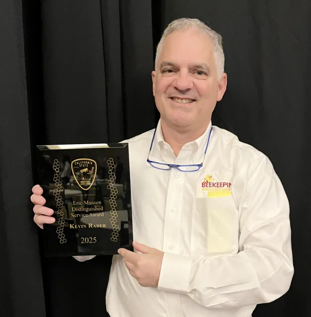 Kevin Rader with Eric Mussen Distinguished Service Award (Photo courtesy of California State Beekeepers' Association)
