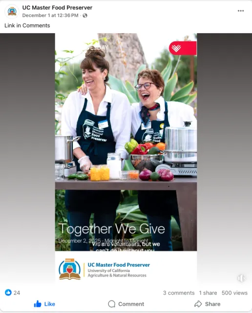 Two women wearing UC Master Food Preserver aprons share a laugh behind a table topped with fruits and vegetables and canning equipment.