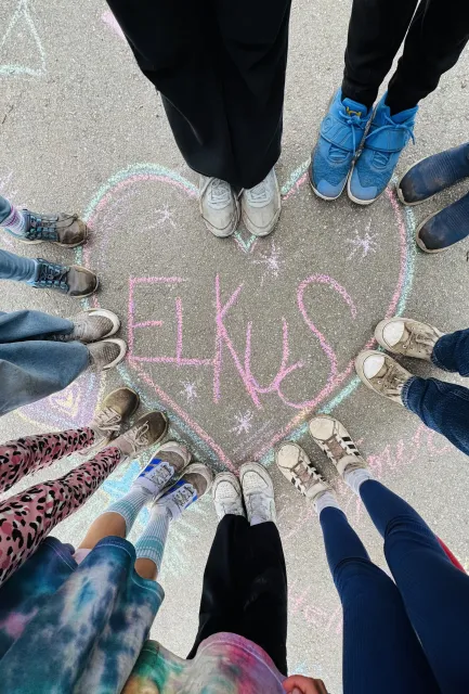 Students around an Elkus heart chalk-drawing showing their love of Elkus Ranch.