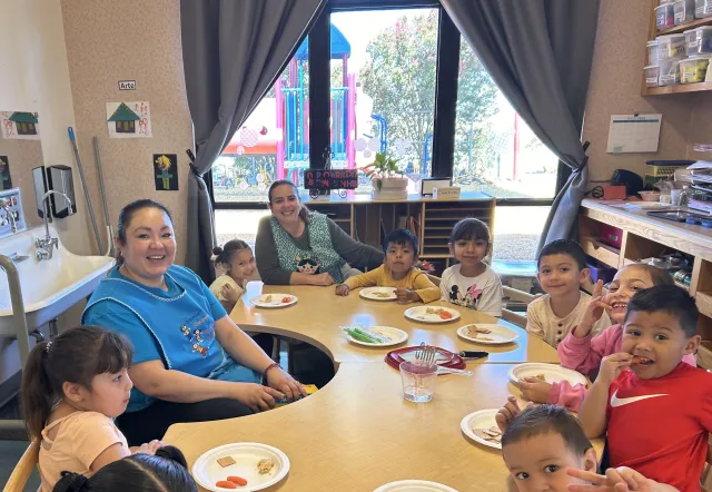 Teachers guide preschool students through Fuel Their Minds tasting activity with garbanzo bean hummus dip, whole wheat crackers, and carrots.