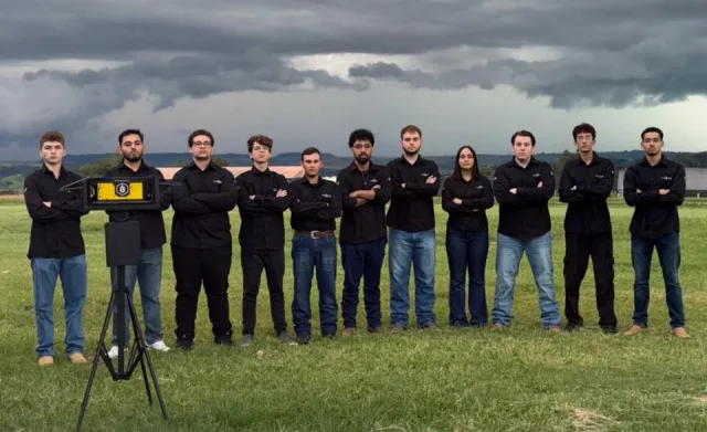 VARD team of Shunji Nishimura College of Technology in Brazil stand in a row in a field