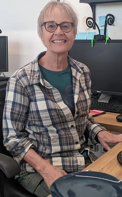 UC Davis Professor Emerita Valerie Williamson at her desk