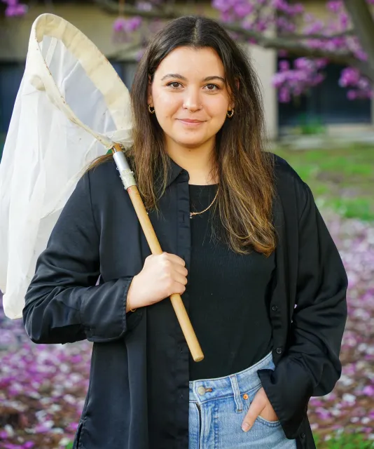UC Davis doctoral candidate Alexia "Lexie" Martin with insect net.