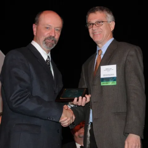 ESA AWARD--ESA President Michael Gray (left) presents the Recognition Award in Insect Physiology, Biochemistry and Toxicology to UC Davis chemical ecologist Walter Leal. (Photo by Kathy Keatley Garvey)