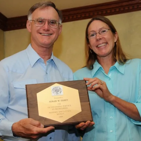 HIGH HONOR--UC Davis bee breeder-geneticist Susan Cobey receives the "Outstanding Service to Beekeeping" award at the Western Apicultural Society conference from president Eric Mussen, Extension apiculturist. (Photo by Kathy Keatley Garvey)