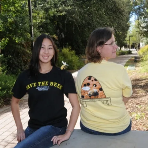 SPORTING the new honey bee t-shirts they created to raise funds for honey bee research at UC Davis are Nanase Nakanishi (left), an animal science major and a student employee at the Bohart Museum of Entomology, and Fran Keller, a doctoral student in entomology. Nanase models the front, and Fran, the back. (Photo by Kathy Keatley Garvey)