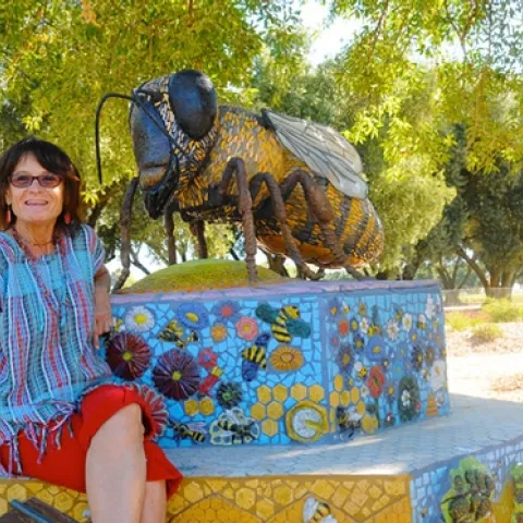 ROCK ARTIST Donna Billick, with her sculpture, "Miss Bee Haven," at the Haagen-Dazs Honey Bee Haven, Harry H. Laidlaw Jr. Honey Bee Research Facility at UC Davis. Billick will be showing some of her work at the Pence Art Gallery, Davis, Nov. 23-Dec. 23. (Photo by Kathy Keatley Garvey)