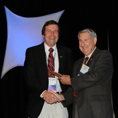 FRANK ZALOM (left), professor and integrated pest management (IPM) with the UC Davis Department of Entomology, receives the "Award for Excellence in IPM" from Entomological Foundation president S. Bradleigh Vinson, professor at Texas A&M. The award, presented at the Entomological Society of America's 58th annual meeting, held in San Diego, was sponsored by the Entomological Foundation and Syngenta Crop Protection. (Photo by Kathy Keatley Garvey)