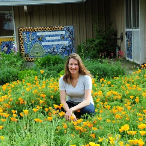 Beekeeper Elizabeth Frost in front of the pollinator patch she planted. (Photo by Kathy Keatley Garvey)