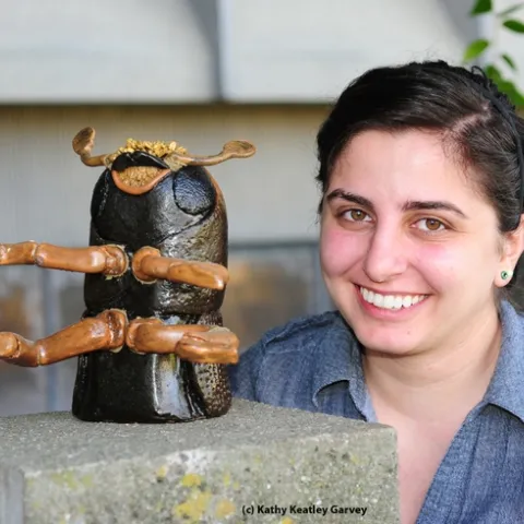 Kristina Tatiossian and the ceramic mosaic of a walnut twig beetle. (Photo by Kathy Keatley Garvey)