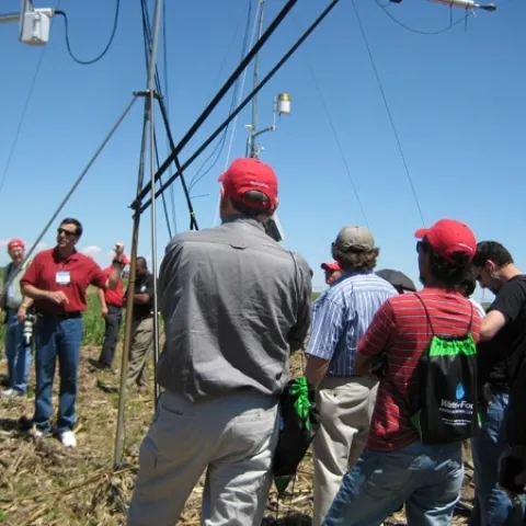 University of Nebraska's Suat Irmak, facing camera, explains how a high-technology weather station in Nebraska continuously monitors crop evapotraspiration and crop coefficients during the growing season. Irmak presents the keynote address to California farmers Sept. 12.