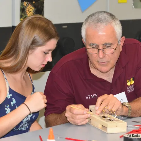 Entomologist Jeff Smith shows Cassidy Hansen fof Rio Vista how to pin a butterly. (Photo by Kathy Keatley Garvey)