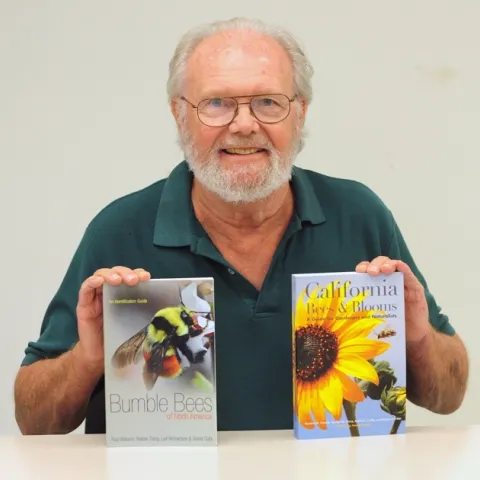 Robbin Thorp with two of the books he co-authored. (Photo by Kathy Keatley Garvey)