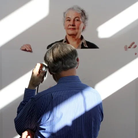 Extension apiculturist (emeritus) Eric Mussen of the UC Davis Department of Entomology and Nematology, stops to listen to a recording about Christiane Nüsslein-Volhard.