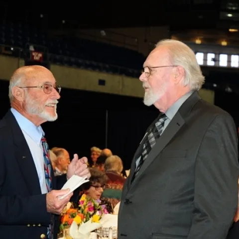 Emcee Bill Rains (left) congratulations Robbin Thorp. (Photo by Kathy Keatley Garvey)