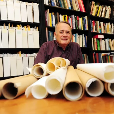 UC Davis Distinguished Professor James R. Carey with some of the maps he used in his research. (Photo by Kathy Keatley Garvey)