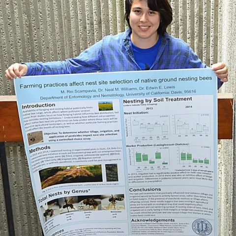 Rei Scampavia with her first-place research poster, “Farming Practices Affect Nest Site Selection of Native Ground Nesting Bees." (Photo by Kathy Keatley Garvey)