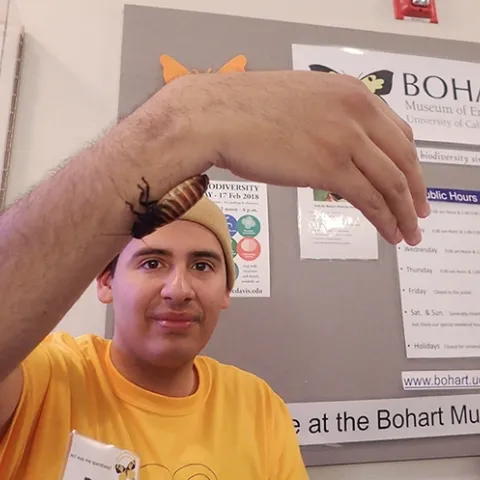 UC Davis student Diego Rivera shows a Madagascar hissing cockroach. (Photo by Kathy Keatley Garvey)