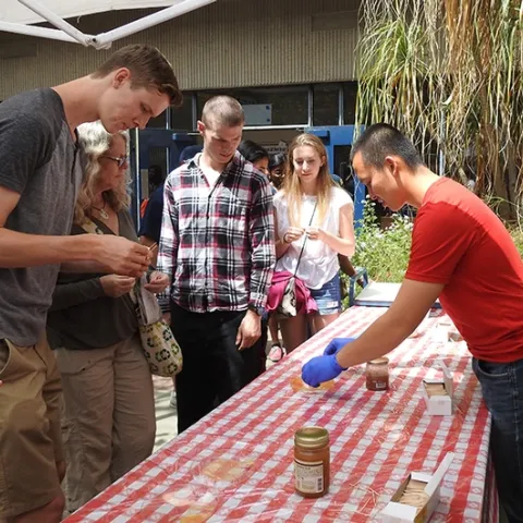 Entomology graduate student Yao Cai (right) of the Joanna Chiu lab helped staff the honey tasting table at Briggs Hall during the 2017 UC Davis Picnic Day. (Photo by Kathy Keatley Garvey)