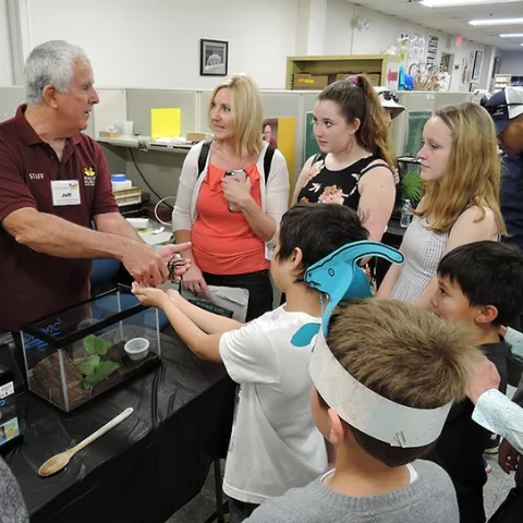 Entomologist and Bohart associate Jeff Smith introduces a crowd to Snuggles, a rose-haired tarantula. (Photo by Kathy Keatley Garvey)