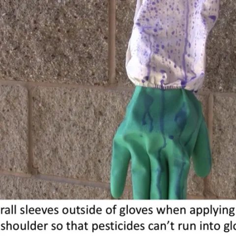 Liquid dripping on coverall sleeves shows that it cannot get into gloves if gloves are tucked into sleeves.