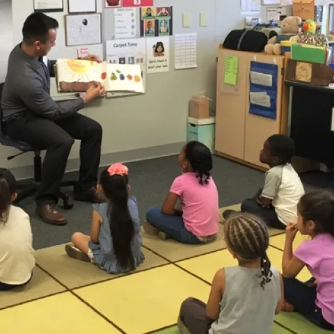 Gerado reads the Hungry Little Catepiller to a class at Slater Elementary.
