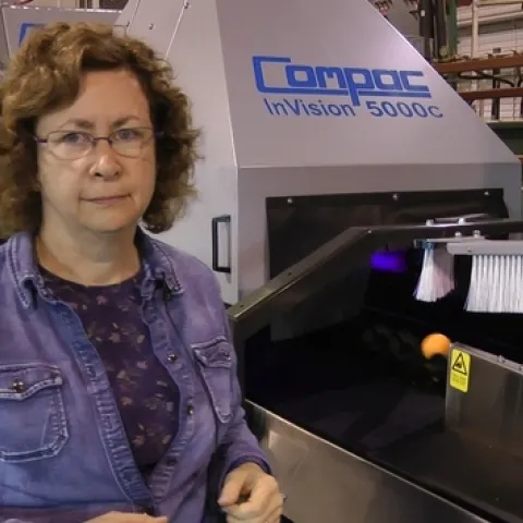 Dr. Beth Grafton-Cardwell in front of the state-of-the-art fruit grader. The equipment purchase was funded by the Citrus Research Board.