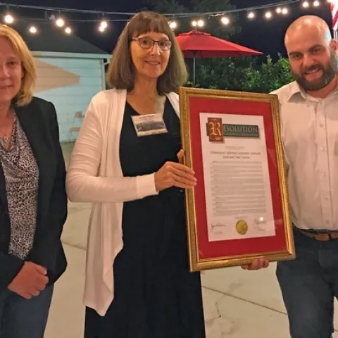 In recognition of UCCE Sutter-Yuba's centennial, Janine Hasey, center, was presented a Senate/Assembly Resolution by Laura Nicholson, senior district representative for state Senator Jim Nielsen, and Joe Brennan, who represented Assemblymember James Gallagher.