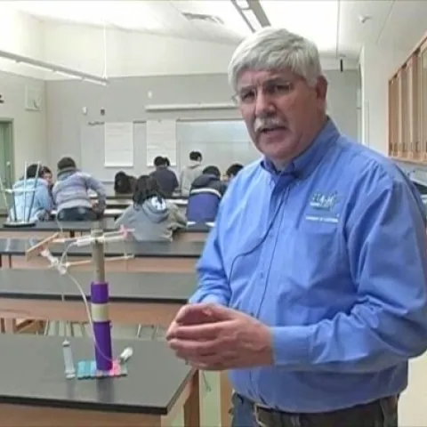 Richard Mahacek with a "junk drawer" robotic arm.