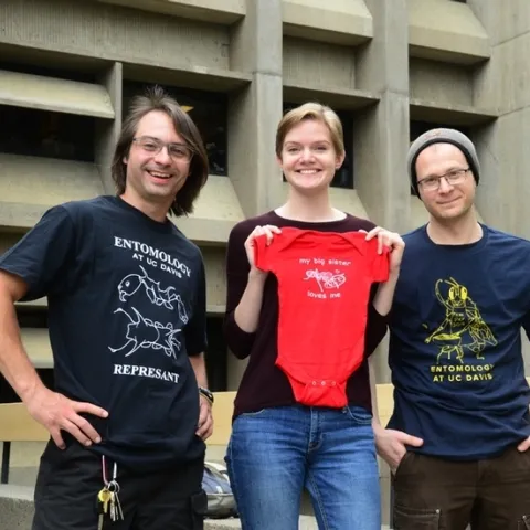 EGSA members and their award-winning t-shirts: president Brendon Boudinot; EGSA t-shirt coordinator Jill Oberski; and Corwin Parker. (Photo by Kathy Keatley Garvey)