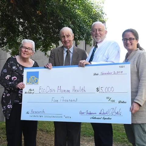 The check presentation: (from left) Bev Anderson, president of the Western Neuropathy Association (WNA); Bruce Hammock, distinguished professor at UC Davis and founder of EicOsis, Darrell O'Sullivan, WNA treasurer; and Cindy McReynolds, an administrator of the Hammock lab and EicOsis senior project manager.(Photo by Kathy Keatley Garvey)