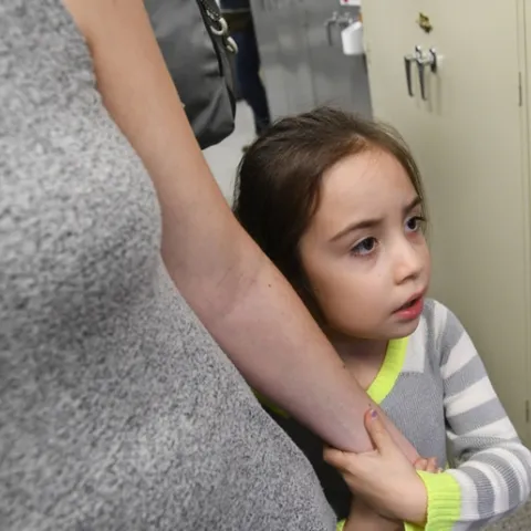 Kira Olmos, 5, of Winters isn't sure she wants meet an Australian stick insect at the Bohart Museum. She is holding mom's hand. (Photo by Kathy Keatley Garvey)