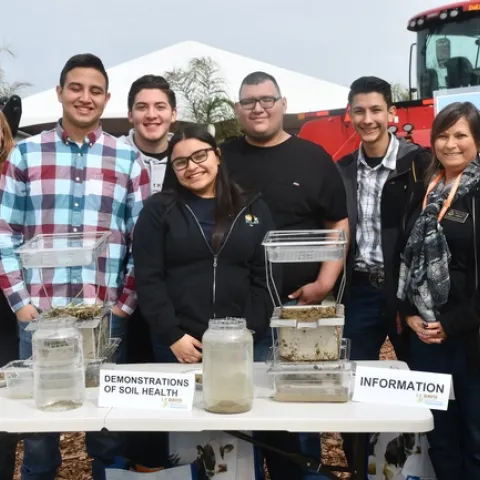 Mira Dick, USDA NRCS Merced (far left) and Sheryl Feit, USDA NRCS Davis (far right) conduct soil health demonstation at the joint CASI and NRCS display site at the 2019 World Ag Expo in Tulare, CA