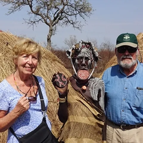 James R. Carey, UC Davis distinguished professor of entomology and his wife, Patty, with a Mursi woman (Ethiopia) showing her lip plate. Also known as a lip disc, it is a status symbol among the Mursi women.