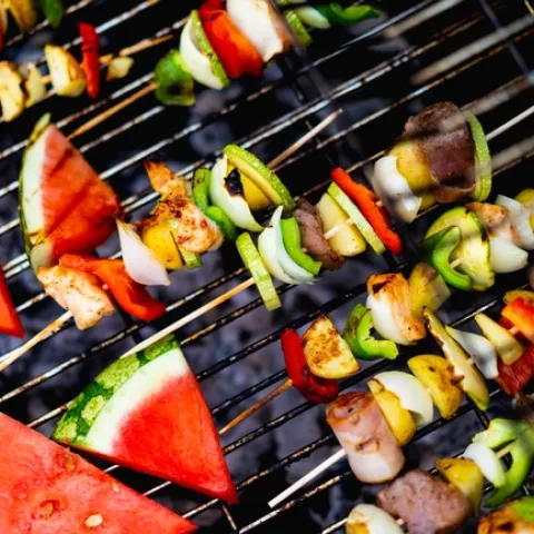 Dan Gold - Unsplash. Photo of vegetable and meat kebobs on a grill.