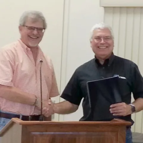 It's all smiles as Director Jeff Dahlberg congratulates David Grantz on his retirement after 29 years.