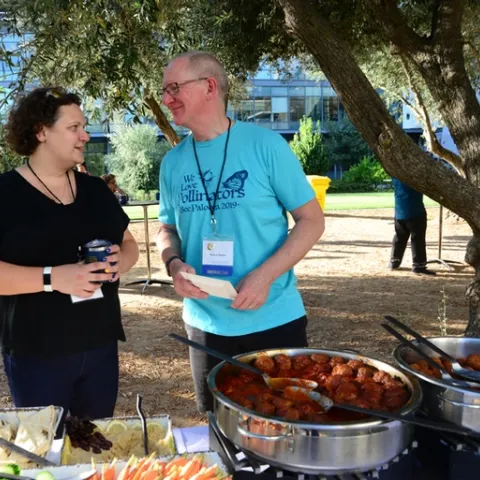 Extension piculturist Elina Lastro Niño of the UC Davis Department of Entomology and Nematology chats with the International Pollinator Conference co-founder Rufus Isaacs of Michigan State University at the Thursday reception. (Photo by Kathy Keatley Garvey)