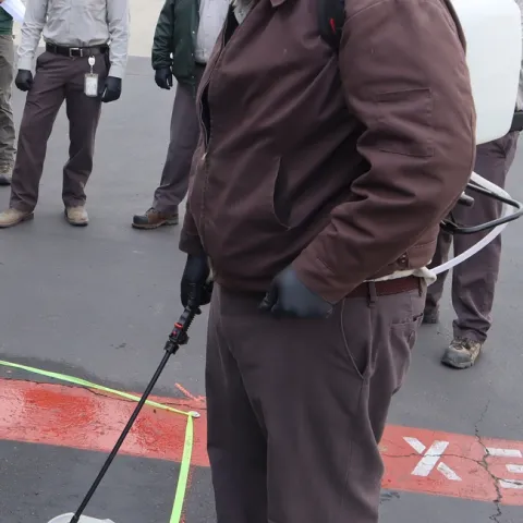 Figure 1. Backpack sprayer pesticide calibration. (Credit: G. Del Rosario, Corteva)