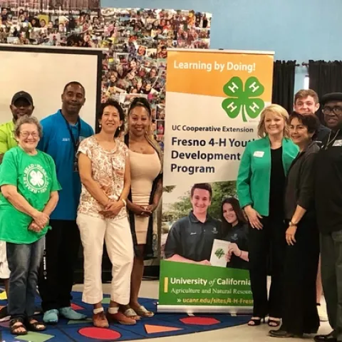4-H community educator Alena Pacheco (in green jacket), introduced Regent Estolano (in white pants) and Sen. Caballero (next to Pacheco) to UCCE Fresno partners Street Saints, who offer a safe place for youth after school where they can develop employment skills through 4-H activities.